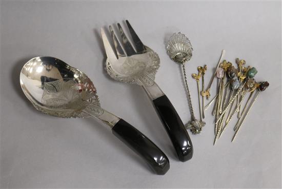 A set of twelve 1930s parcel gilt silver cocktail sticks, one other set of six, a pair of Malaysian servers and a filigree spoon .